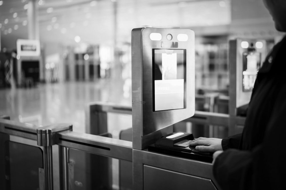 A man scans his passport at a streamlined immigration check